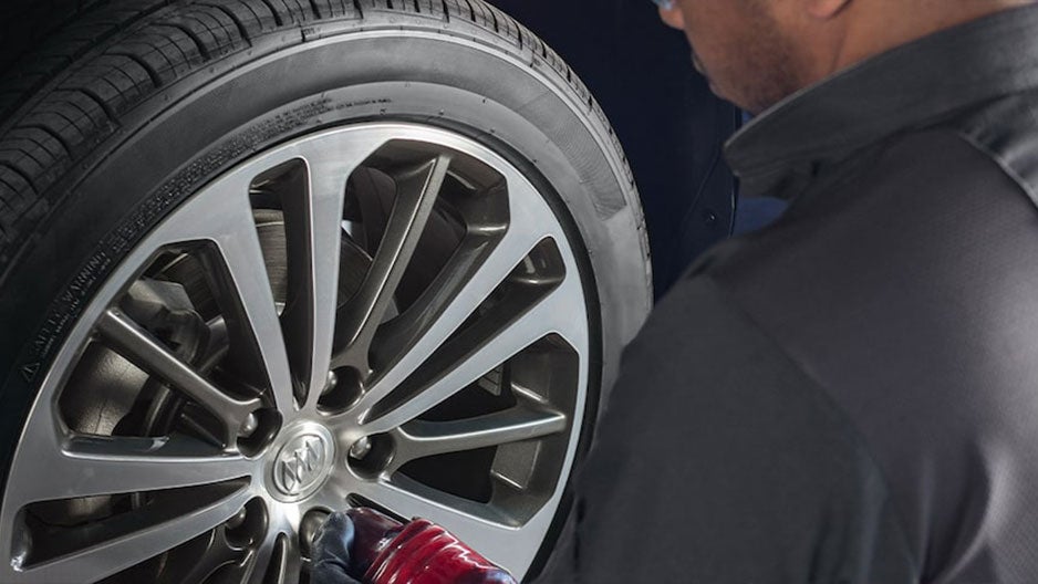 Checking the car's wheel - Finnegan Chevrolet Buick GMC in Rosenberg TX