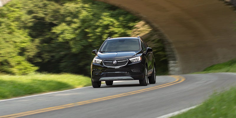 Black Buick Encore driving down highway