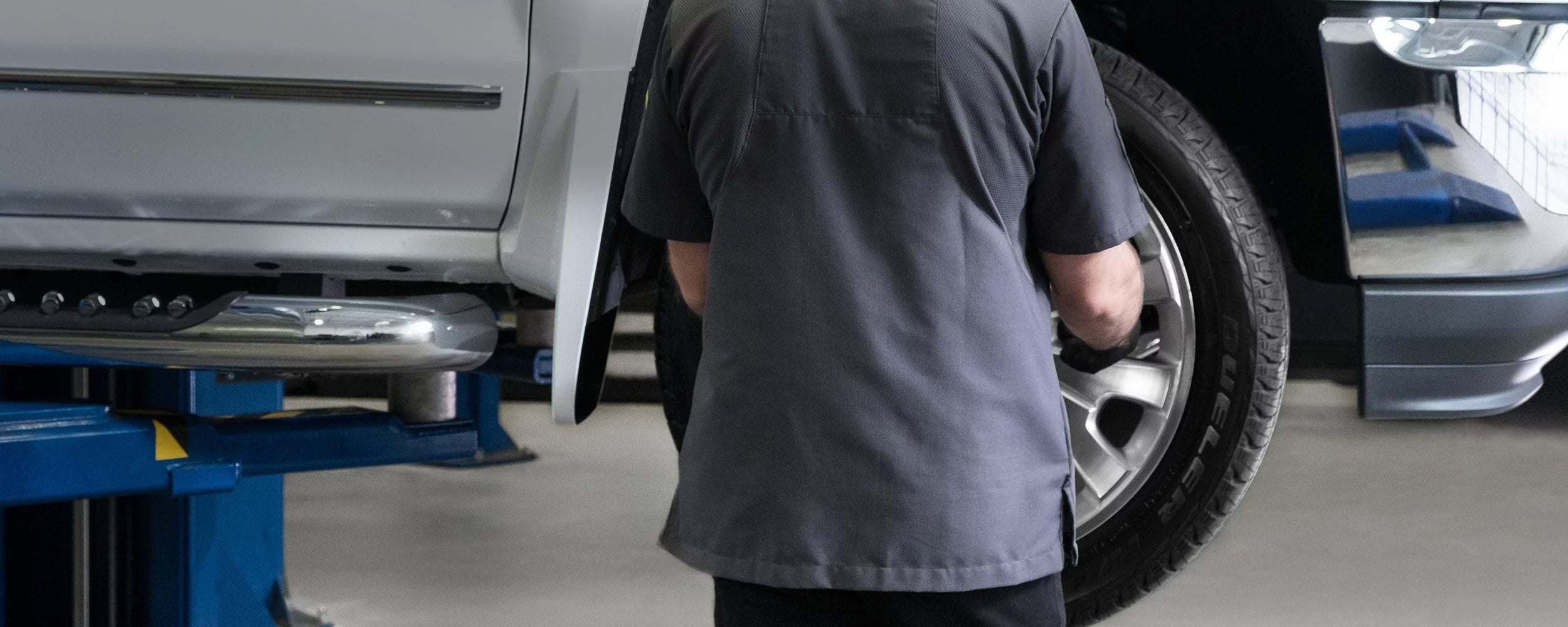 Mechanic working on a car - Finnegan Chevrolet Buick GMC in Rosenberg TX