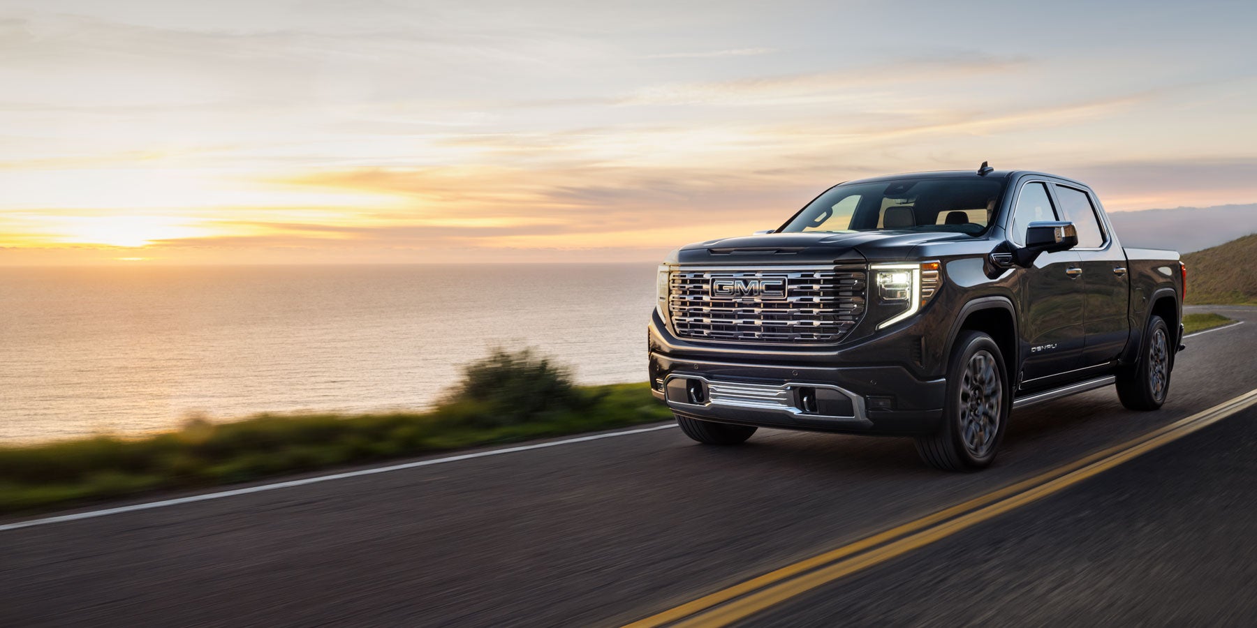 GMC Truck driving on the road - Finnegan Chevrolet Buick GMC in Rosenberg TX