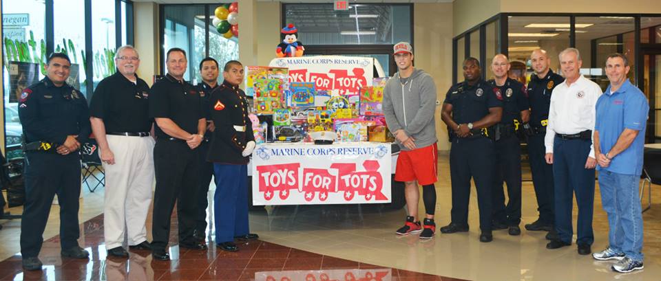 The Finnegan team with the Mayor, Rosenberg Police, a member of the Marine Corps Reserve, and pro football player Brian Cushing during our Toys for Tots toy drive.